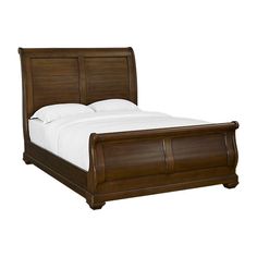 a wooden bed frame with white sheets and pillows