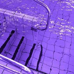 an empty swimming pool with purple water