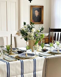 a dining room table is set with plates and place settings for two people to eat