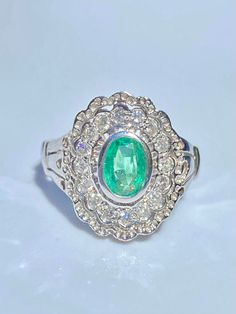 Art Deco inspired Emerald ring of 0.65 carats. Emerald is oval brilliant cut and mounted in 14k white gold setting. Intricate floral ring design mounts a vibrant light green Colombian Emerald center stone. ✔ Gold Karat: 14K ✔ Emerald Weight: 0.65 carats ✔ Emerald Origin: Colombia ✔ Emerald Cut: Oval ✔ Diamond Weight: 0.20 carats total ✔ Diamond Color: H-I ✔ Diamond Clarity: SI1 ✔ Ring Weight: 4.90 grams ✔ Certificate of appraisal included upon request SHIPPING TIMES USA: 3-14 business days (USPS Oval Emerald Ring In 14k White Gold, Exquisite Oval Emerald Ring, Gia Certified Oval Diamond Ring In Diamond White, Classic White Gold Diamond Ring With Oval Cabochon, Gia Certified Oval Diamond Ring For Anniversary, Platinum Oval Cabochon Ring With Center Stone, Green Oval Emerald Ring In Platinum, Dazzling Oval Emerald Ring For Formal Occasions, Formal White Gold Emerald Ring With Oval Cabochon