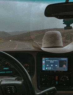 there is a man in the driver's seat of a bus with a hat on