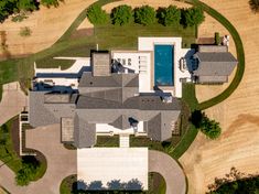 an aerial view of a large house in the middle of a field