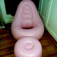 an inflatable chair and foot stool are on the floor next to each other