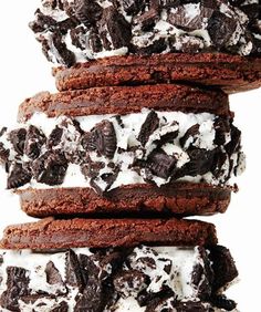 chocolate cookies and oreo cookies stacked on top of each other with white frosting