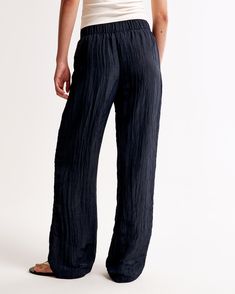 Elevate your wardrobe with the Abercrombie & Fitch Women's Crinkle Textured Pull-On Pants in a stunning Dark Indigo. These ultra high-rise, wide-leg pants are the epitome of comfort and style, crafted from a breezy, crinkle-textured fabric that ensures both durability and breathability.

- Size: Medium
- Color: Dark Indigo
- Material: Body - Polyester, Elastane; Lining - Polyester
- Gender: Female
- Features: Elasticated waistband, functional pockets

Perfect for a casual day out or a relaxed ev Spring Wide-leg Pants With Crinkle Texture, Spring Wide-leg Crinkle Texture Pants, Casual Summer Pants With Crinkle Texture, Summer Loungewear Bottoms With Crinkle Texture, Casual Wrinkled Wide Leg Bottoms, Summer Loungewear Pants With Crinkle Texture, Summer Wide Leg Bottoms With Crinkle Texture, Summer Wide Leg Pants With Crinkle Texture, Summer Wide Leg Crinkle Texture Pants