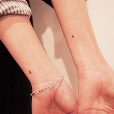 two people with matching tattoos on their arms