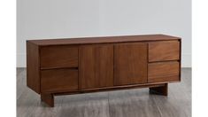 the sideboard is made out of wood and has three drawers on one side, two doors on the other