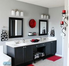 a bathroom with two sinks, mirrors and red rugs on the floor in front of it