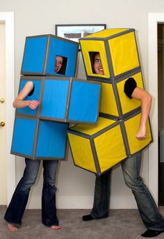 two people dressed up as rubik and rubik cubes with faces on them