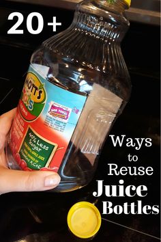 a hand holding a bottle of juice with the words 20 ways to reuse juice bottles