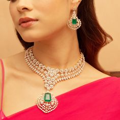 Description : Shine like a queen on your special day with the Blooming CZ Grand Silver Necklace. Crafted with high-quality CZ stones and a striking central emerald green stone, this statement necklace is great to be the highlight of the event. Style it with a dress or with your favorite saree, it will be equally alluring. Product Information : Materials used: 925 Silver with Gold & White Gold Plating Stones: Semi-precious stones Length: Necklace-18.5cm Earrings-5cm Findings: Hook and links Elegant Green Diamond Necklace With Jewels, Elegant Green Diamond Necklace, Dazzling Emerald Necklace With Jewels, Cubic Zirconia Necklace For Party, May Birthstone, Diamond Emerald Necklace For Party, Fine Jewelry Emerald Necklace With Diamonds For Party, Dazzling Emerald Necklaces For Party, Wedding Necklaces With Diamond Accents For May Birthstone, Dazzling Emerald Necklace For Party