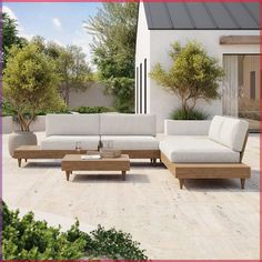 a couch and table on a patio with trees in the backgroung area