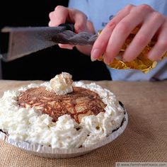 a person with a knife and some food on a table