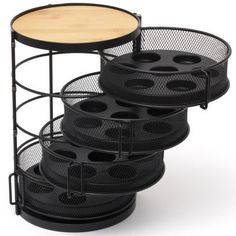 three tiered trays with black mesh and wood top, each holding different items