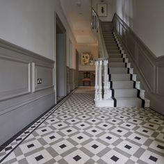 the stairs are lined with black and white tiles