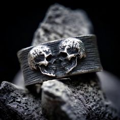 Elevate your eternal vow with this exquisitely crafted stainless steel gothic wedding ring.  Made from high-quality 316L stainless steel, this ring features a captivating double skull detail, symbolizing the unity of two souls in an unbreakable bond. With its sleek design and enduring durability, this ring is a timeless symbol of love and devotion.  Make a statement on your special day with this unique and hauntingly beautiful piece. Handmade to order 🖤 Gothic Groom, Gothic Wedding Ring, Gothic Wedding Rings, Goth Ring, Skull Wedding Ring, Alternative Wedding Bands, Mens Jewellery, Skull Wedding, Rustic Rings