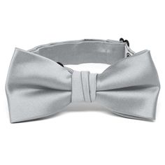 We designed this boys' light silver bow tie to match with our popular men's ties. The collar is pre-tied with a band sized for most boys from baby to 10-years old. The heavyweight woven material and smooth satin finish provides a sharp look that is suited for formal occasions. We recommend this shade for a light gray color. Sizing This bow tie features an adjustable band that expands to fit most babies, toddlers and children up to 10-years old. For older children, pre-teens and teens, we suggest Silver Ties For Black Tie Occasions, Adjustable Silver Ties For Black Tie Events, Classic Adjustable Solid Color Bow, Classic Adjustable Solid Bow, Adjustable Silver Suit And Tie Accessories For Black Tie, Silver Adjustable Accessories For Black Tie Suit, Classic Adjustable Satin Bow Tie, Classic Silver Tie, Classic Silver Adjustable Suit And Tie Accessories