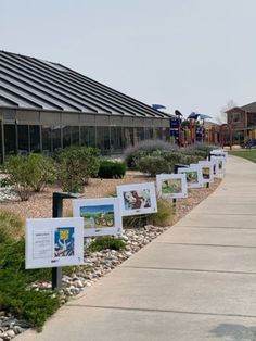 the walkway is lined with posters and plants