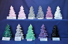 there are many different colored christmas trees on display