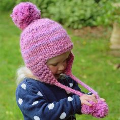 This is a very quick and easy to knit earflap hat with pompoms. The smaller sizes can be knit in an evening.Children love pompoms. My little model loved playing with them!The pattern gives both knit flat and knit in the round instructions. Just choose whichever method you are most comfortable with.As with all my patterns there are plenty of photos to help you along the way. There is also a photo tutorial at the end for making pompoms from cardboard if you have never made them before.The patte... Knit Earflap Hat, Baby Hats Knitting Free, Julie Taylor, Knitted Flower Pattern, Knitting Patterns Free Dog, Hats For Babies, Baby Hat Knitting Pattern, Flap Hat, Earflap Hat