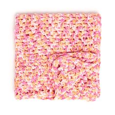 a pink and yellow crochet blanket on a white background with a bow at the end