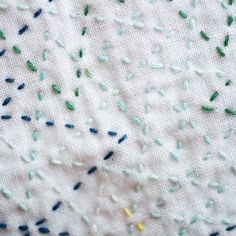 some sprinkles on a white cloth with blue and green colors in it