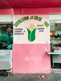 a sign on the side of a building that says tortilleria la chila