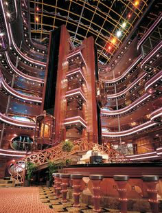 the interior of a large building with lights on it's ceiling and staircases