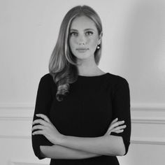 black and white photo of a woman with her arms crossed