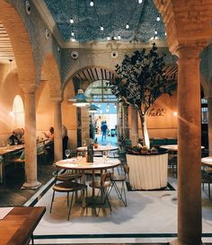 the inside of a restaurant with tables and chairs