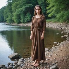 This brown long sleeve maxi dress combines rustic boho style with cottagecore charm. Featuring a belted waist and a simple, flowy design, it's perfect for fall outings, LARP events, or casual, everyday wear. The dress is comfortable and versatile, making it a go-to option for those who love a minimalist yet earthy aesthetic. Its soft fabric and relaxed fit ensure all-day comfort while looking effortlessly chic. I hope you will love my design as much as I enjoyed creating it for you! ----Important Information---- Please, be aware that all pictures are designer's illustrations. The actual product may slightly differ in look. Also, a costume does not include anything else but the costume itself. Belts, purses, or leather accessories are not included; though we can make them for you for some e Fall Outings, Dress Minimalist, Earthy Aesthetic, Larp Costume, Flowy Design, Brown Long Sleeve, Cottagecore Dress, Minimalist Dresses, Rustic Boho