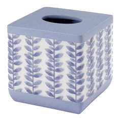 a blue and white ceramic tissue dispenser with leaves on the front side