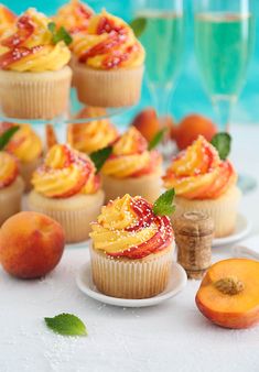 cupcakes and peaches on a white table