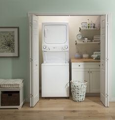 a washer and dryer sitting in the corner of a room with green walls