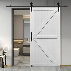 an open barn door in a bathroom with white walls and tile flooring on the side