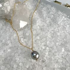 This beautiful necklace features one lustrous 10mm Tahitian Pearl Pendant, dangling from a sparkly bar & link chain finished off with 2" extender and a dangle of gold beads.The Tahitian Pearl is lighter in color, but still have gorgeous luster with shades of gray and beautiful shine. Paired with the bar & link chain, it is a stunning combination!Each pearl is one of a kind with variations in color, shape & luster. This makes each piece of jewelry truly unique! All pearls are the highest quality Tahitian Pearl Pendant, Shades Of Gray, Link Chain Necklace, Tahitian Pearls, Beautiful Necklace, Chain Link Necklace, The Bar, Pearl Pendant, Gold Beads