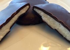 two pieces of chocolate covered doughnut on a plate