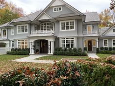 a large gray house with lots of windows