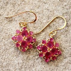 These earrings might be the most beautiful pair that you own! Make a statement with these Pink Sapphire multi semi-precious gemstone earrings set in 22K gold Stone: Sapphire Colour: Pink  Design: Multi-Gemstone Diamond Metal: 22K Gold Plated (brass base) with 22K Gold Vermeil hooks (Hypoallergenic)  Drop Length: ~3 - 3.2cm Earring Width: ~1.8cm  Gift Boxes: each unique piece is also beautifully packaged in the gift box shown, perfect for giving as a gift or safe keeping. 1 Day Shipping Policy: A Fine Jewelry Cluster Drop Earrings As Gift, Gold Gemstone Cluster Earrings For Anniversary, Formal Gold Cluster Earrings With Gemstone, Gold Gemstone Cluster Earrings For Formal Occasions, Anniversary Gold Cluster Earrings With Gemstones, Fine Jewelry Gemstone Flower Earrings As Gift, Fine Jewelry Flower Earrings With Gemstones For Gift, Gemstone Earrings In Flower Shape For Gifts, Yellow Gold Flower Shape Cluster Earrings For Gift