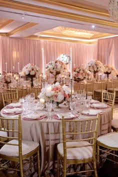 the tables are set with white and pink centerpieces for an elegant wedding reception