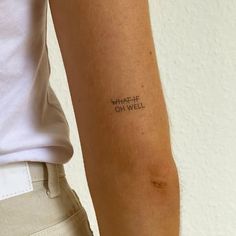 a person with a tattoo on their arm that says what life is on well written in cursive writing