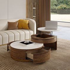 a living room filled with furniture and a laptop computer on top of a coffee table