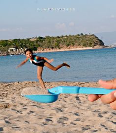 a person is playing on the beach with a frisbee in front of them