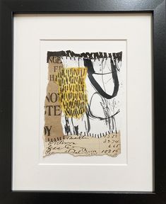 an abstract painting with black and yellow paint on paper, framed in a black frame