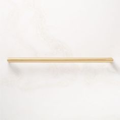 a gold colored handle on a white wall