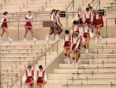 the cheerleaders are all dressed in red and white