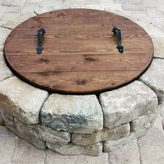 a wooden table sitting on top of a stone wall