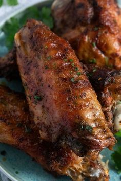 two pieces of chicken on a plate with parsley