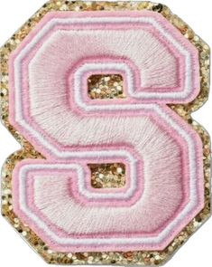 the letter s is made out of pink and gold sequins with glitter on it