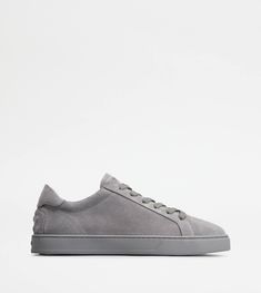 A sober and sophisticated taste characterizes these sneakers with minimal lines, with Tod's logo on the tongue. Crafted in soft suede, they come with a rubber outsole with embossed rubber pebbles. Classic Pants, Grey Sneakers, Driving Shoes, Orange Leather, Soft Suede, Gray Jacket, Large Black, Online Boutique, Online Shop